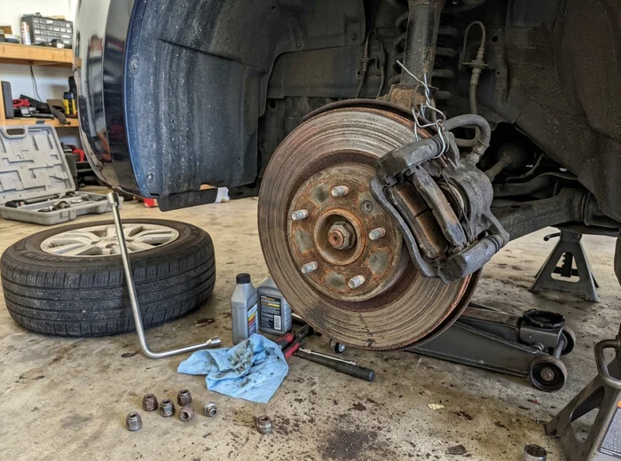 Scored and rust-edged brake rotor before replacement