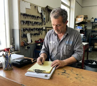 Owner Alex Pinto writing up a repair estimate at the service counter